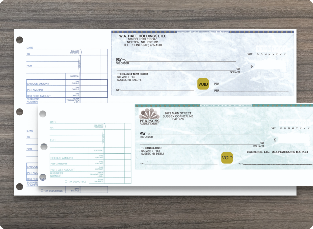 A 2 UP Blue Manual Cheque and a Green 1 UP Manual Cheque on top of a wooden background.