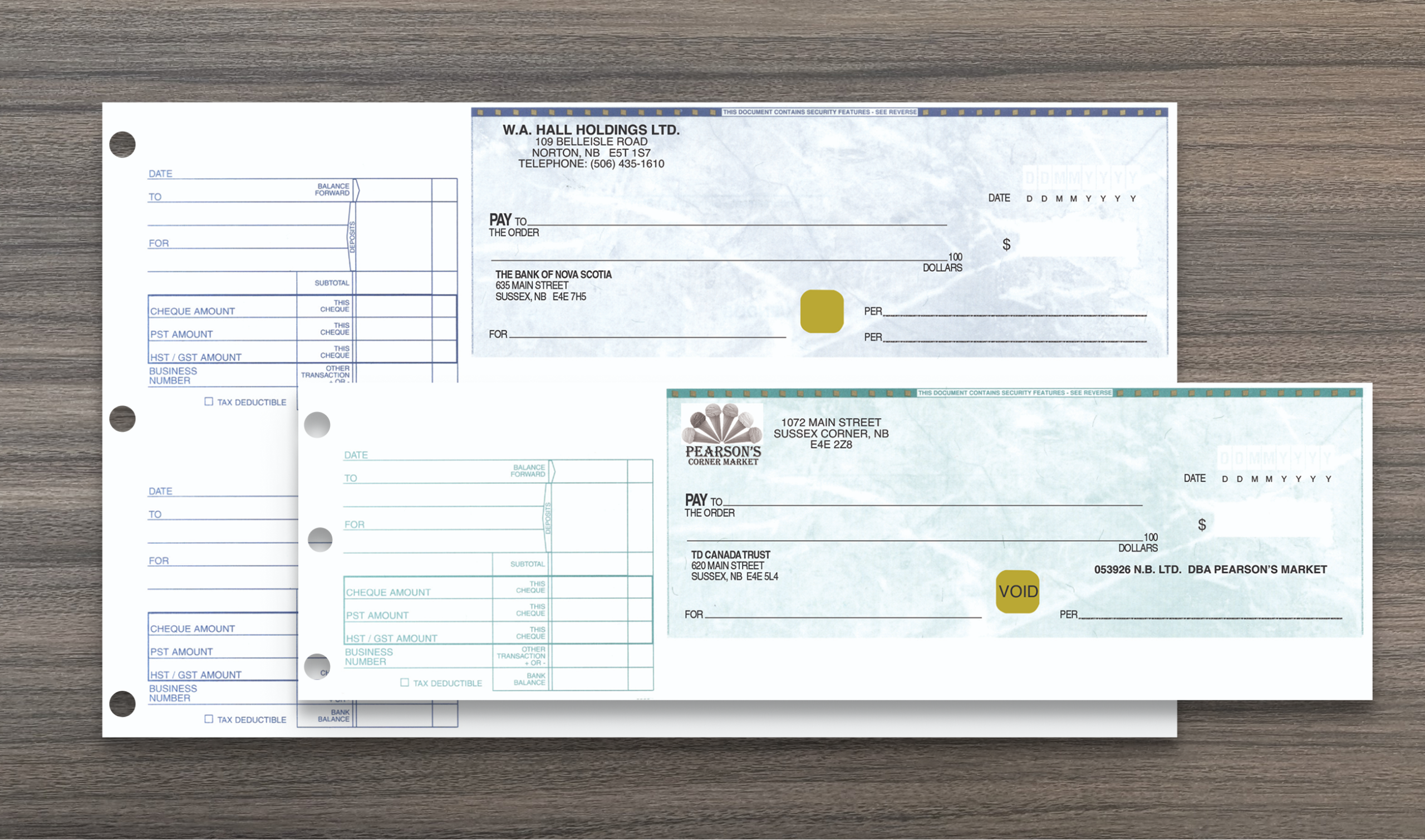 A blue 2UP and green 1 UP secure business cheques, manual cheques. On a wood grain background.