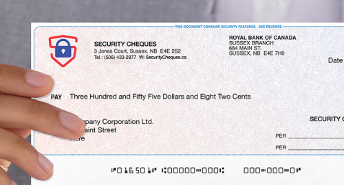 Person wearing a suite and holding a Security cheques laser cheque.